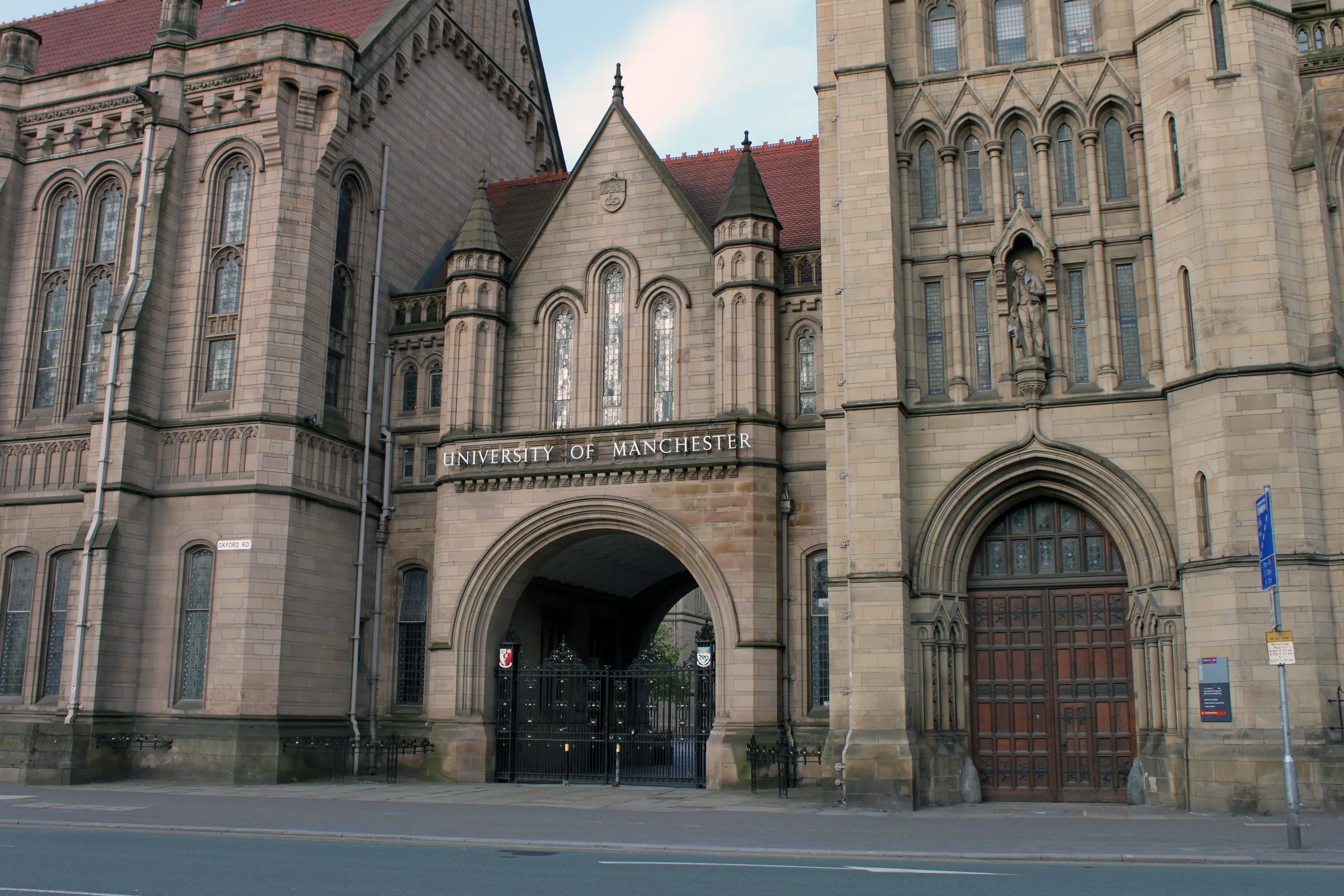 Entrance to Whitworth Hall at the University of Manchester, showing its Gothic Revival red sandstone facade.
